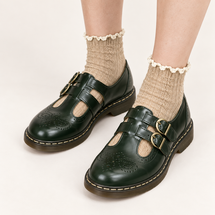 Aurora dark green double-buckle shoes worn, clean studio view
