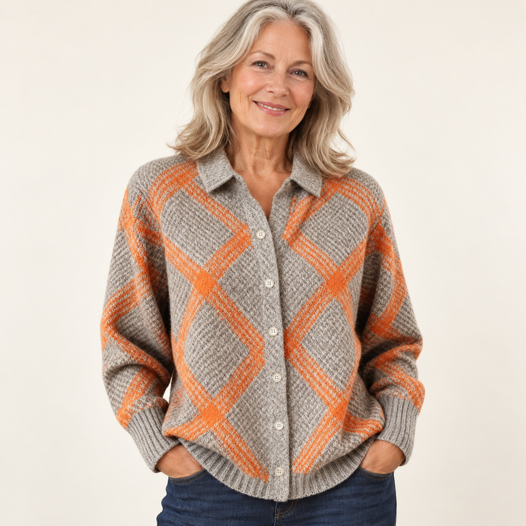 Mature British woman wearing the CHRISTELLE checked blouse on a clean warm off-white studio background