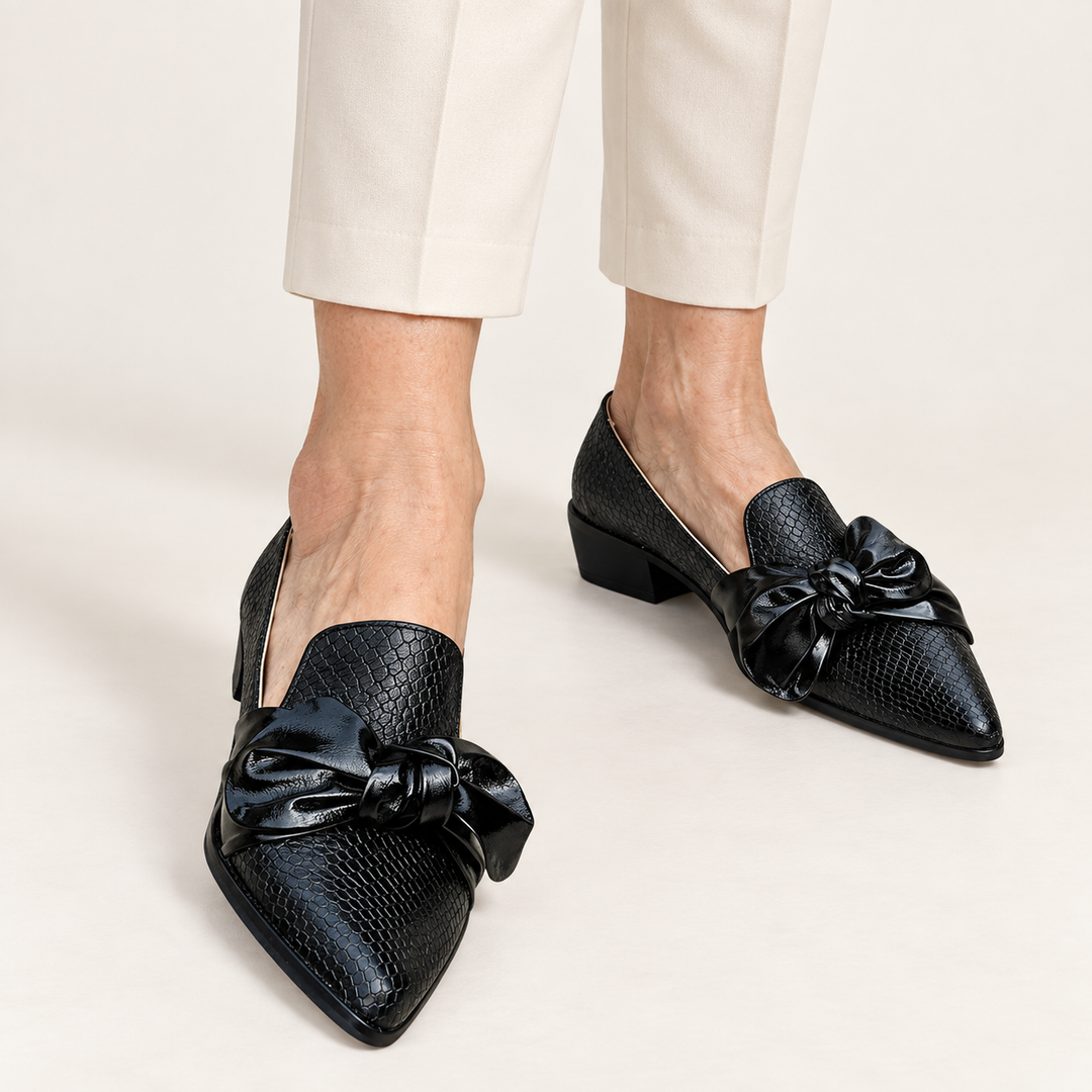 Elena pointed black bow shoes worn close-up