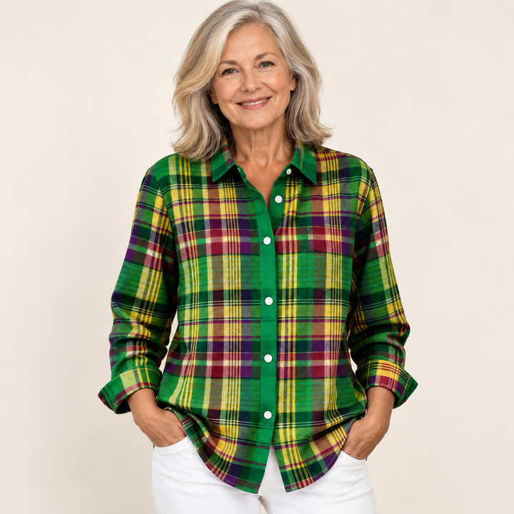 Mature British woman wearing the ELINDRA checked blouse on a clean warm off-white studio background
