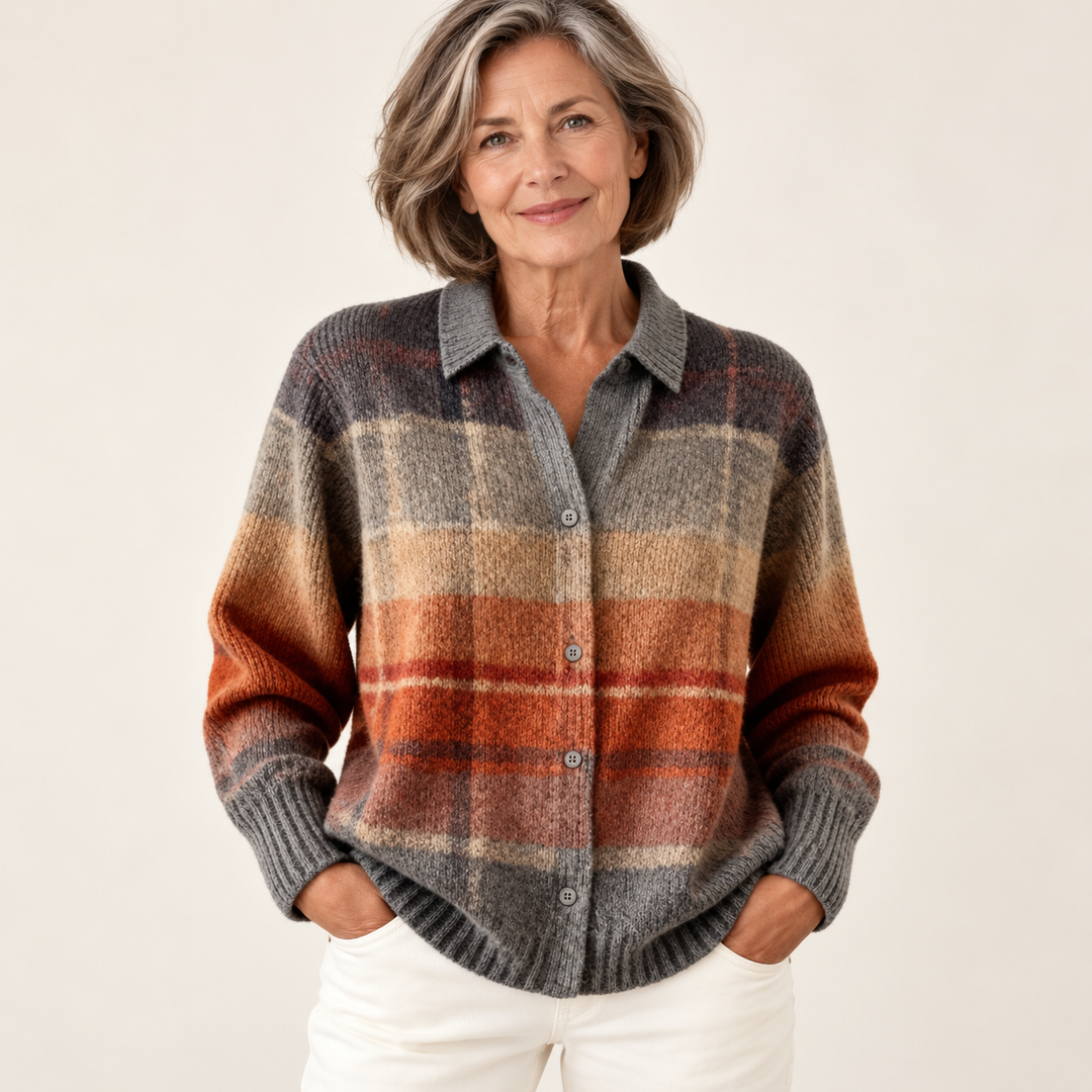 Mature British woman wearing the FLORIA blouse on a clean warm off-white studio background
