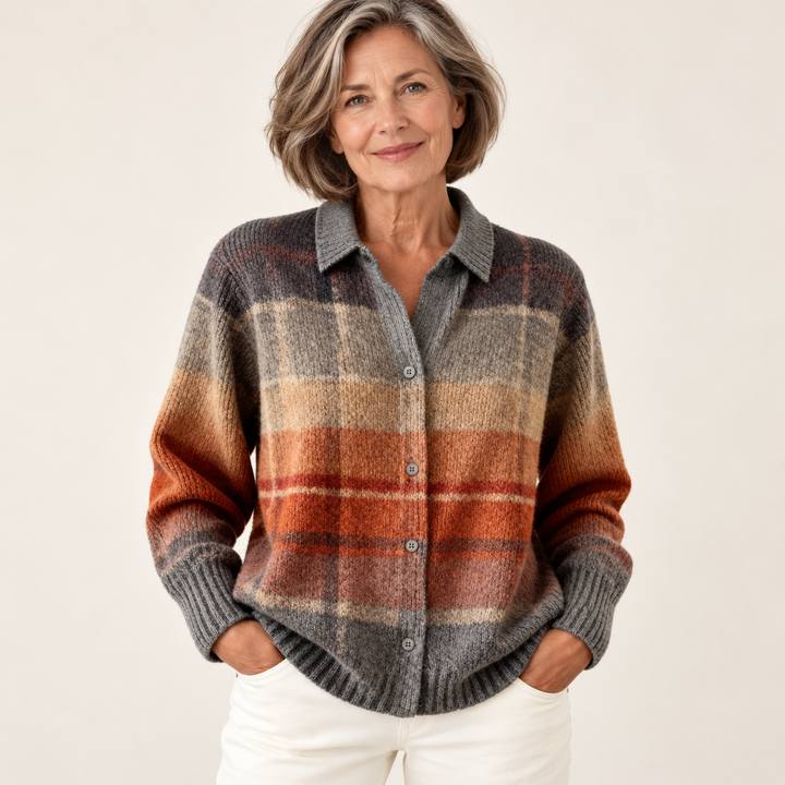 Mature British woman wearing the FLORIA blouse on a clean warm off-white studio background