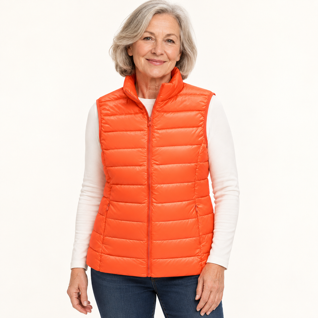 ISA Orange padded gilet on mature model in clean studio