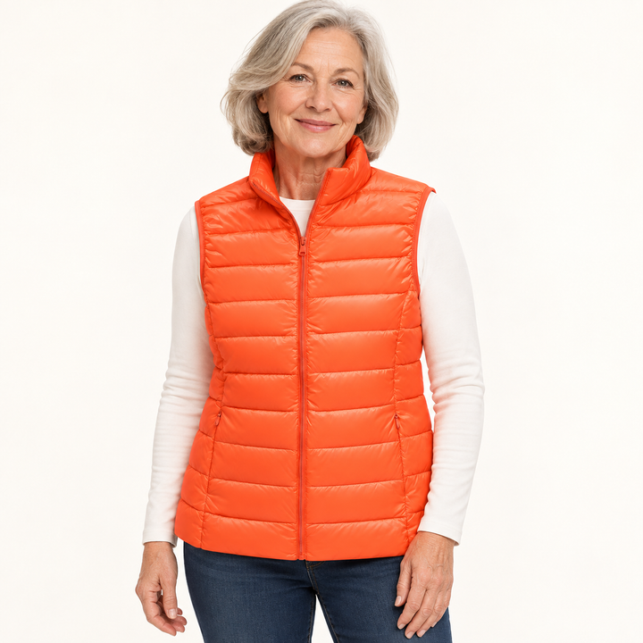ISA Orange padded gilet on mature model in clean studio