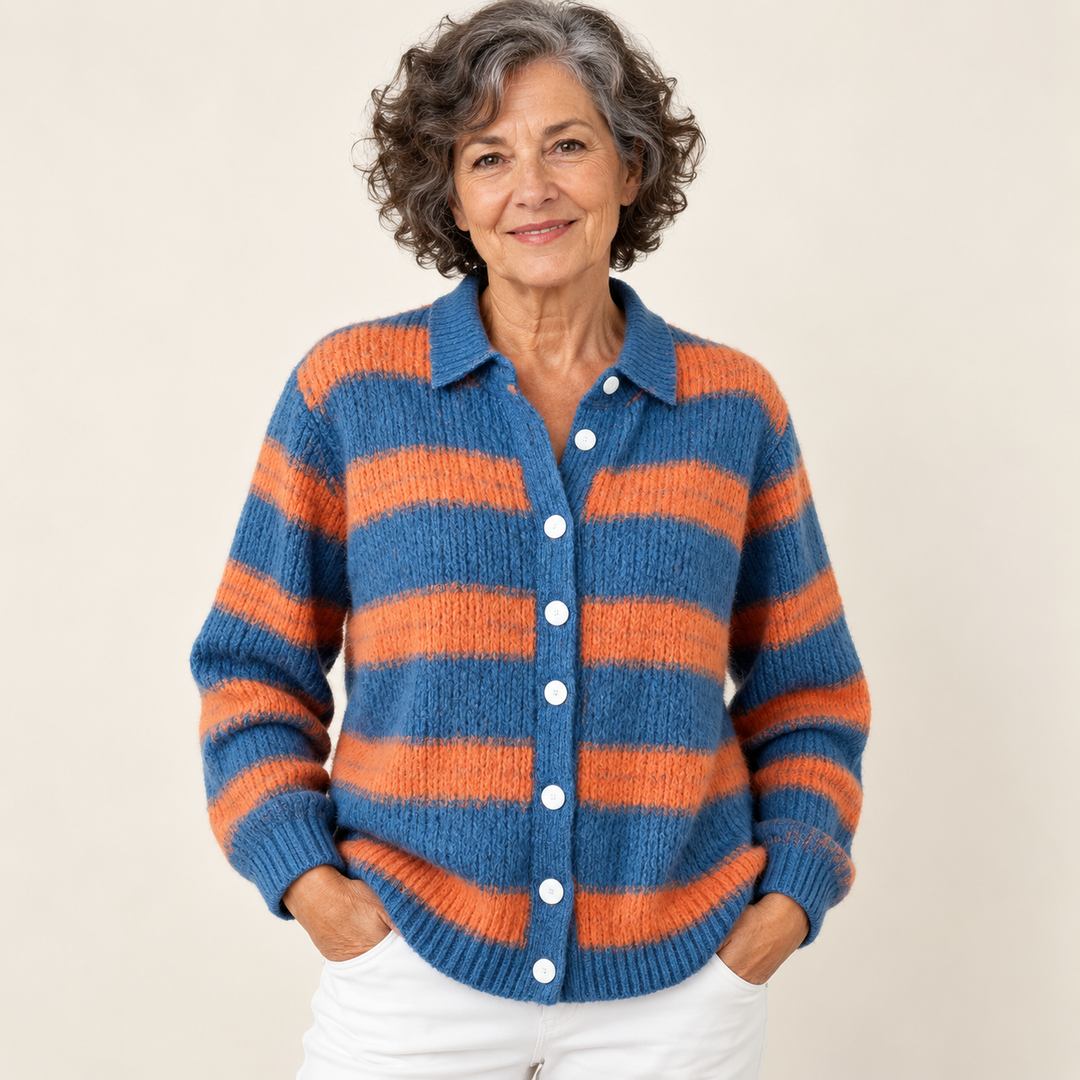 Mature British woman wearing the LIRENA blouse on a clean warm off-white studio background