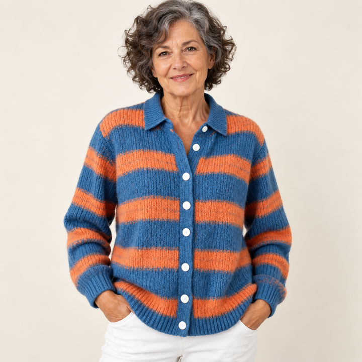 Mature British woman wearing the LIRENA blouse on a clean warm off-white studio background