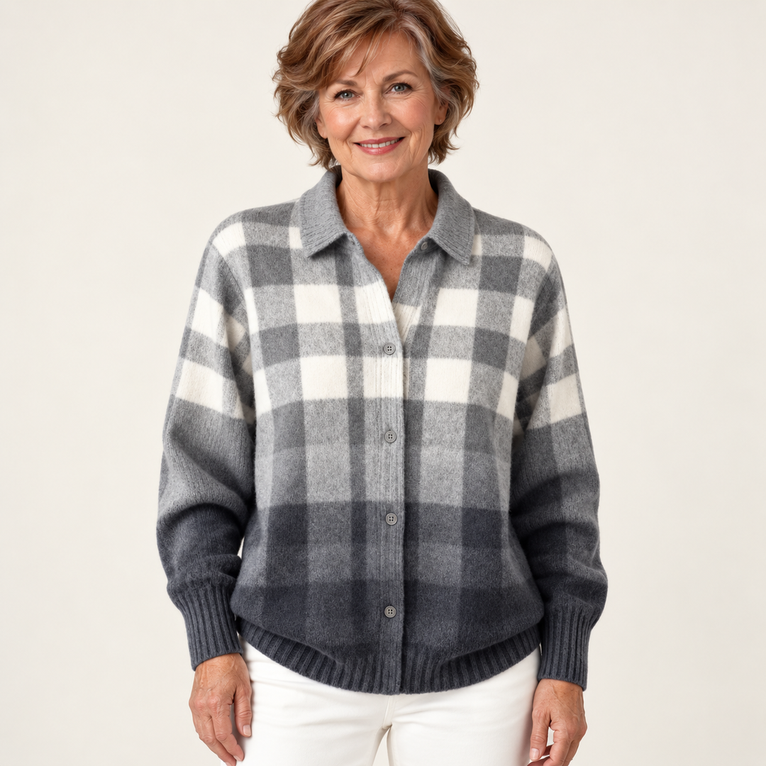 Mature British woman wearing the MARIELLE blouse on a clean warm off-white studio background