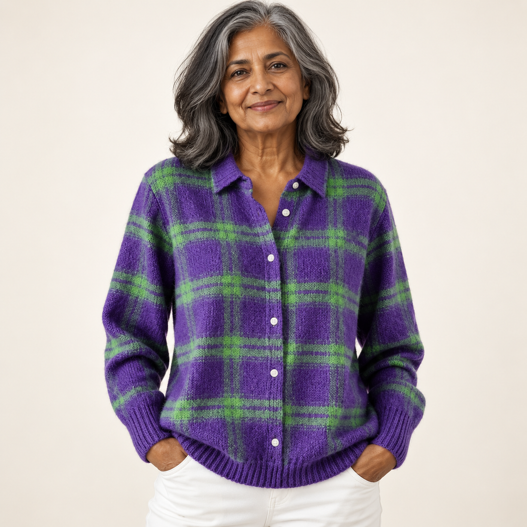 Mature British woman wearing the MARILOU blouse on a clean warm off-white studio background