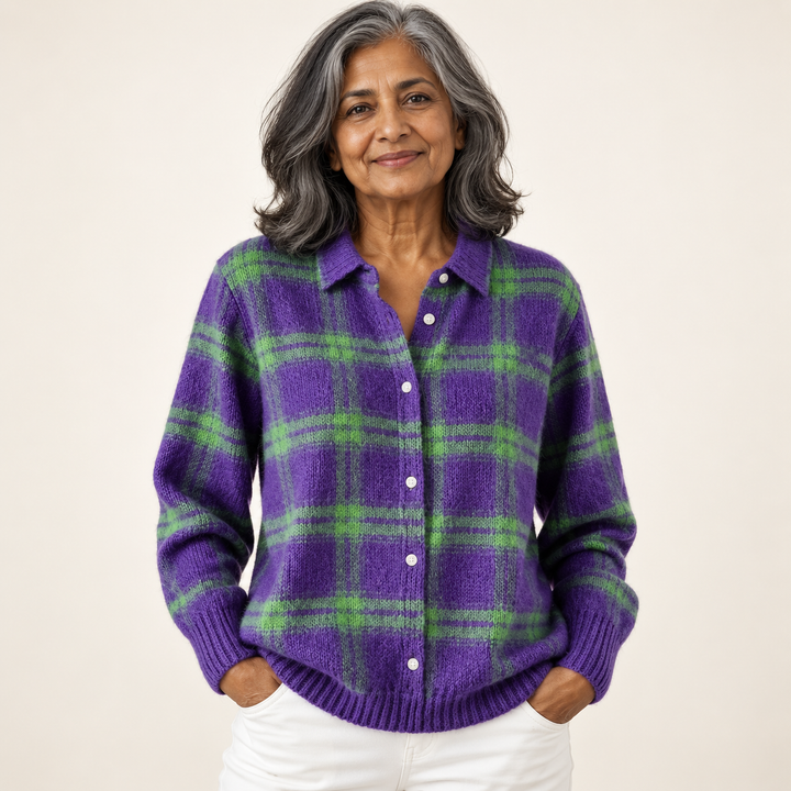 Mature British woman wearing the MARILOU blouse on a clean warm off-white studio background