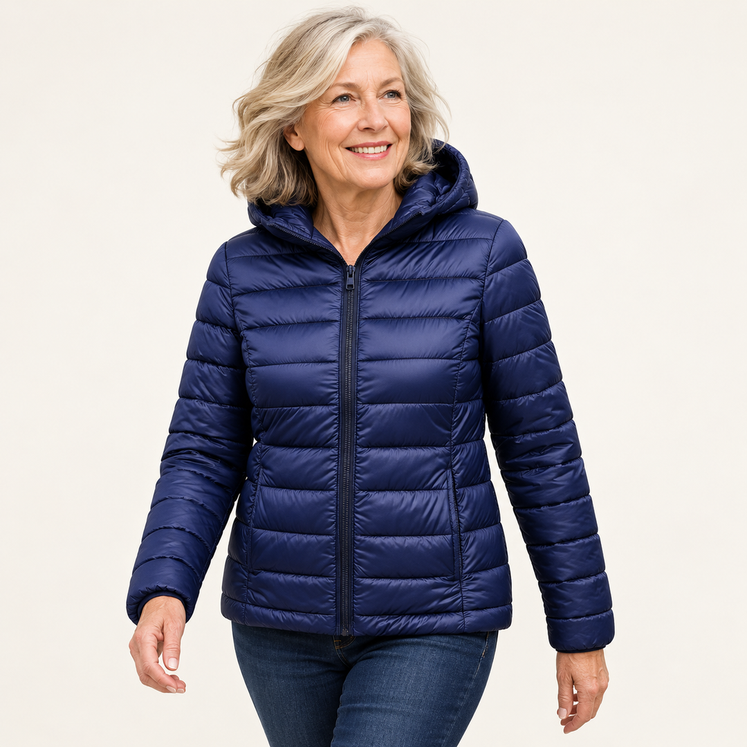 Metta transitional padded jacket in navy blue — mature model natural pose