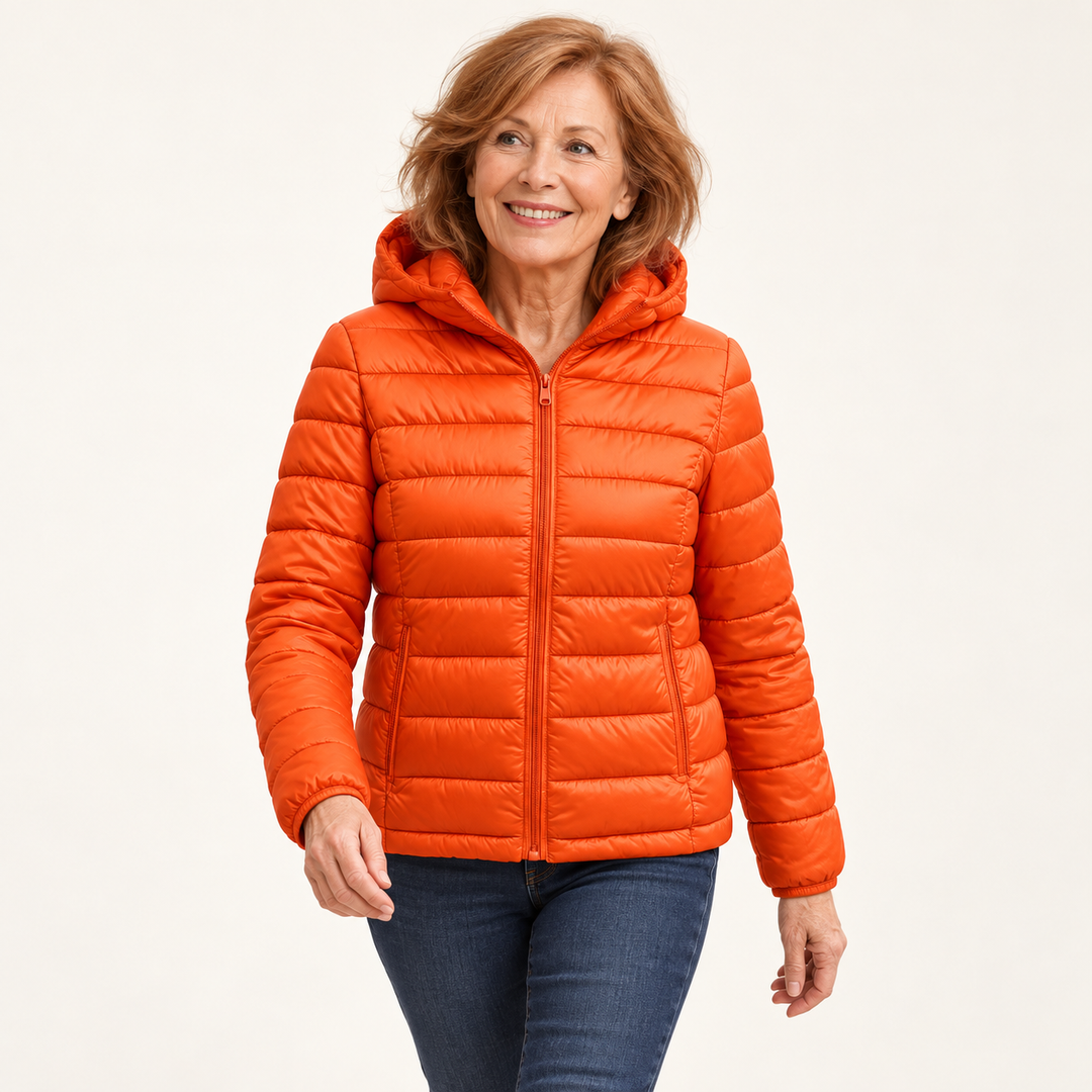 Metta transitional padded jacket in orange — mature model natural pose