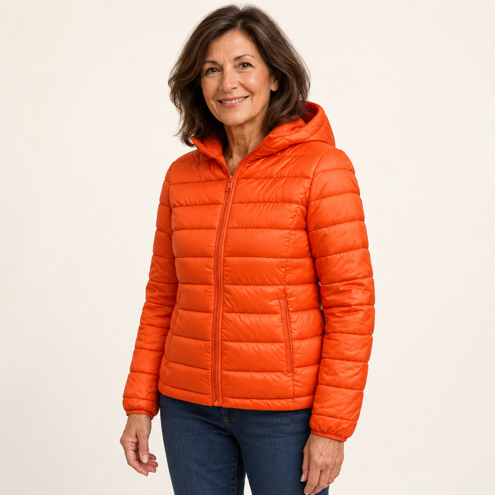 Metta transitional padded jacket in orange — mature model three-quarter view