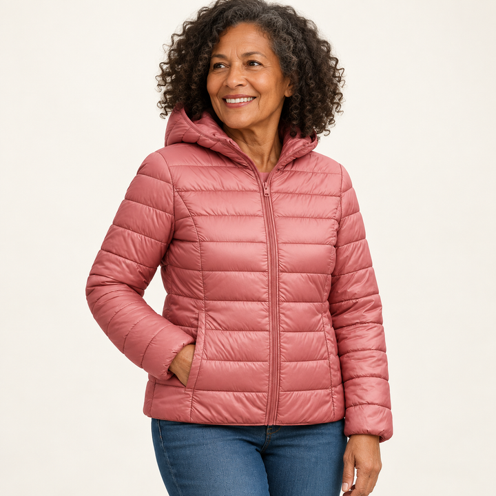 Metta transitional padded jacket in salmon pink — mature model three-quarter view