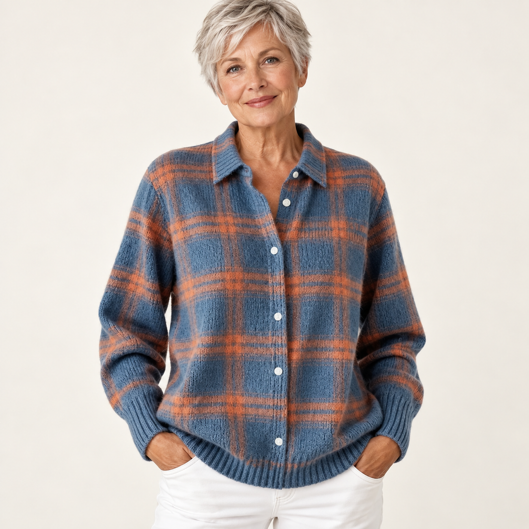 Mature British woman wearing the MIRELLA blouse on a clean warm off-white studio background