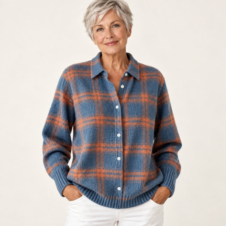 Mature British woman wearing the MIRELLA blouse on a clean warm off-white studio background