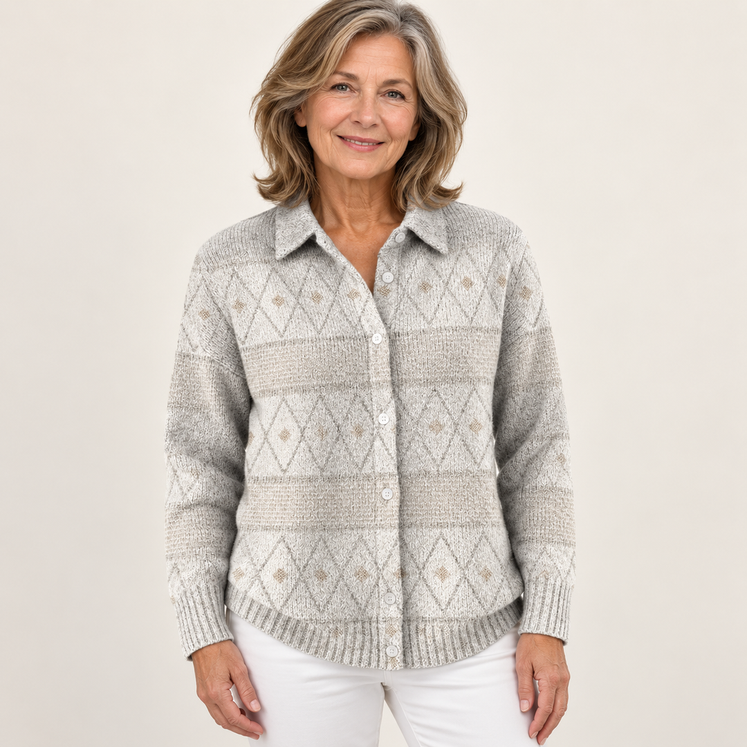 Mature British woman wearing the MONIRA blouse on a clean warm off-white studio background