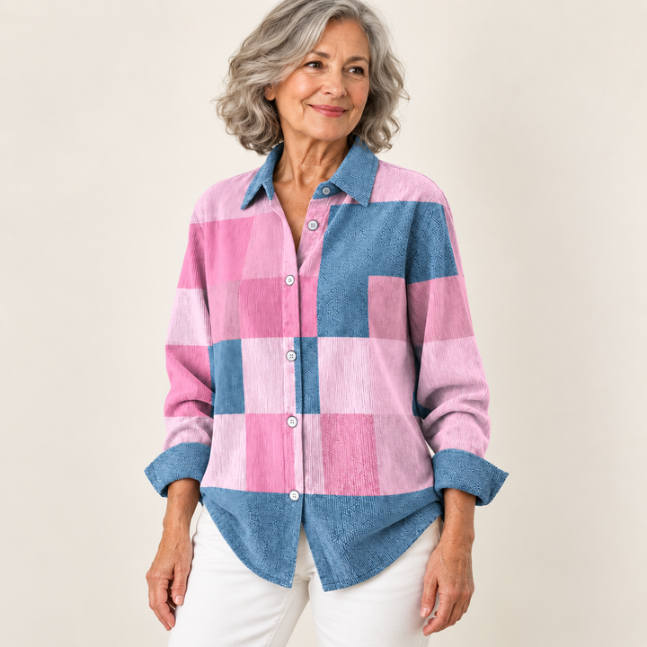 NORAYA pink and blue blouse worn by a mature British woman in a three-quarter studio view