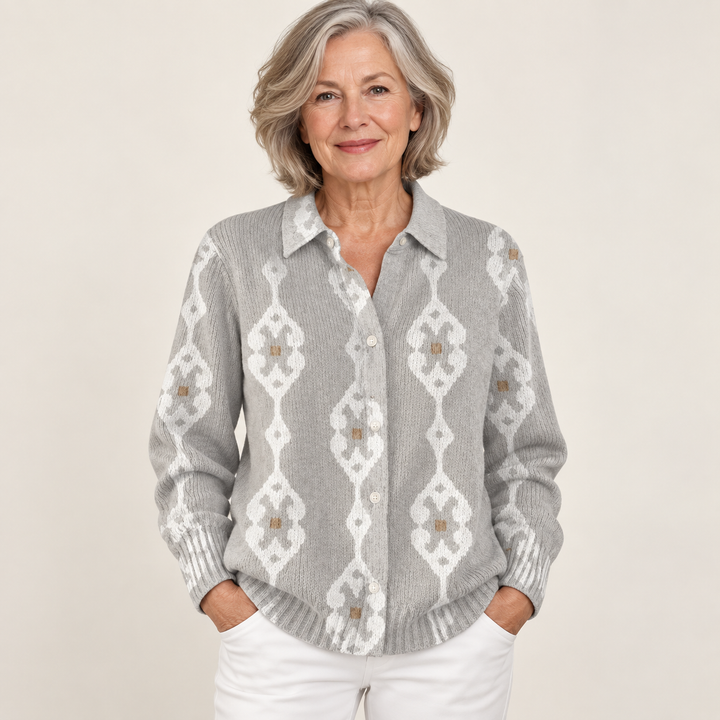 Mature British woman wearing the RENAE blouse on a clean warm off-white studio background