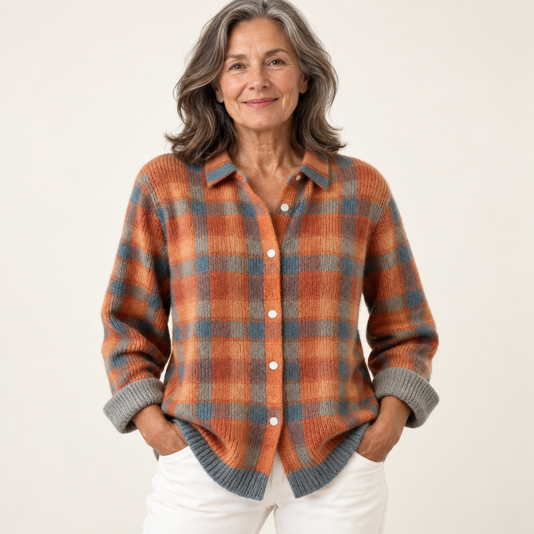 Mature British woman wearing the SAFIYA blouse on a clean warm off-white studio background