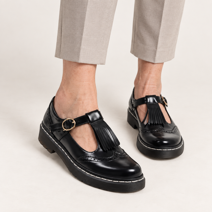 Sofia fringed Mary Jane shoes in Black worn close-up