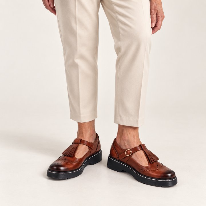 Sofia fringed Mary Jane shoes in Brown worn close-up