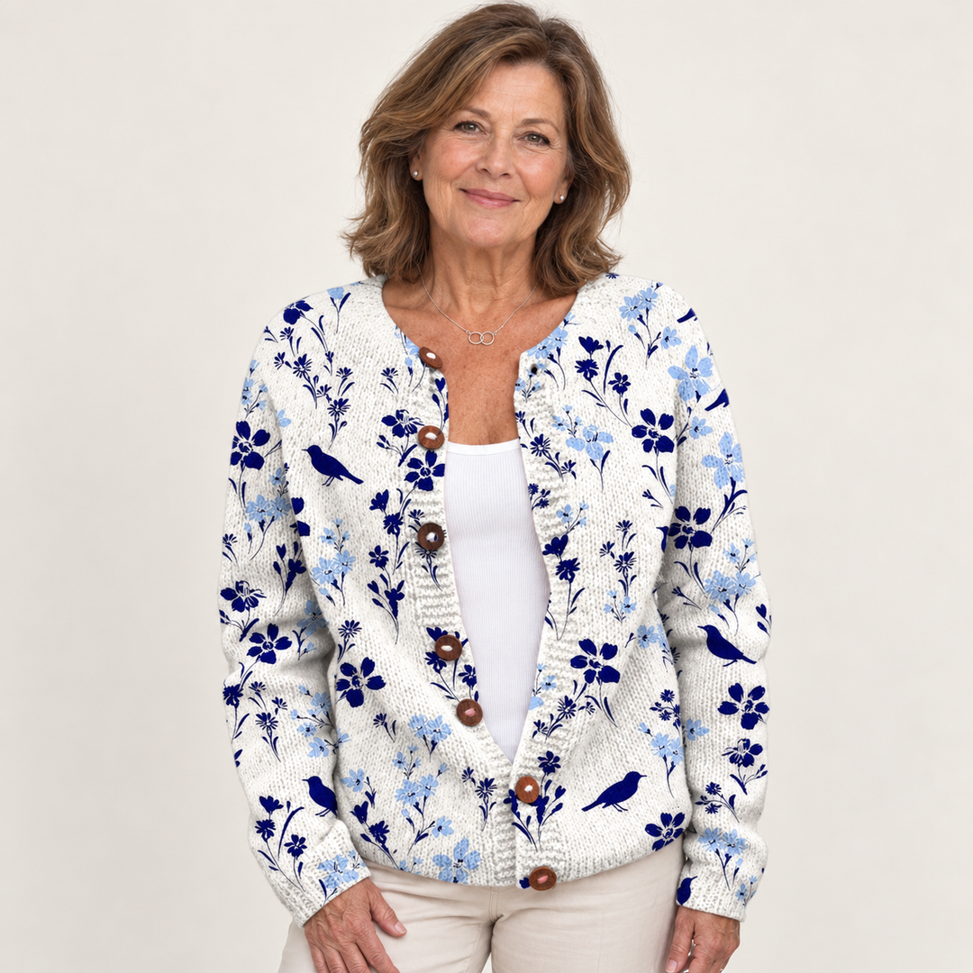 Vynora | Knitted cardigan with floral and bird print and wooden buttons worn by a mature woman on a clean background