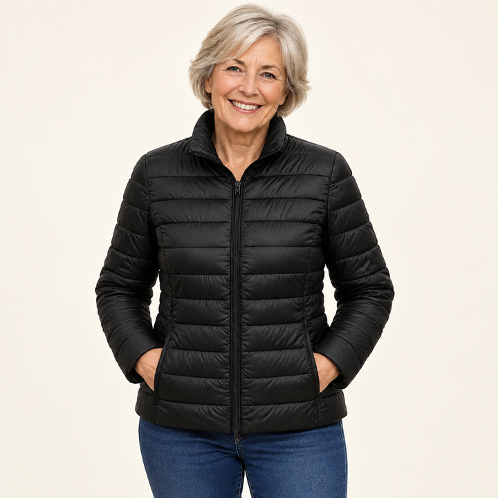 Ulla transitional padded jacket in Black worn by a mature woman, natural studio pose