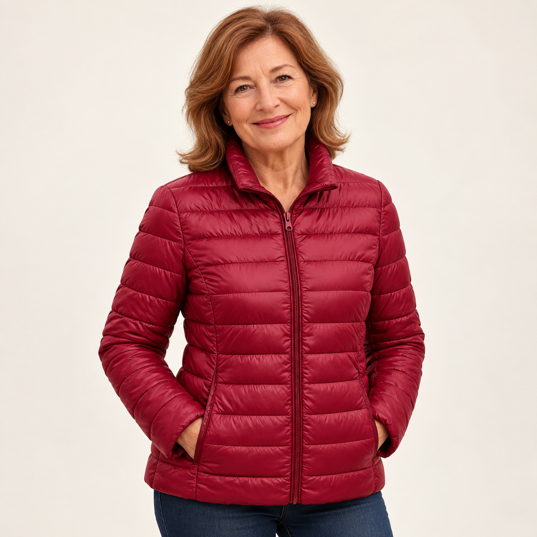 Ulla transitional padded jacket in Dark Red worn by a mature woman, natural studio pose