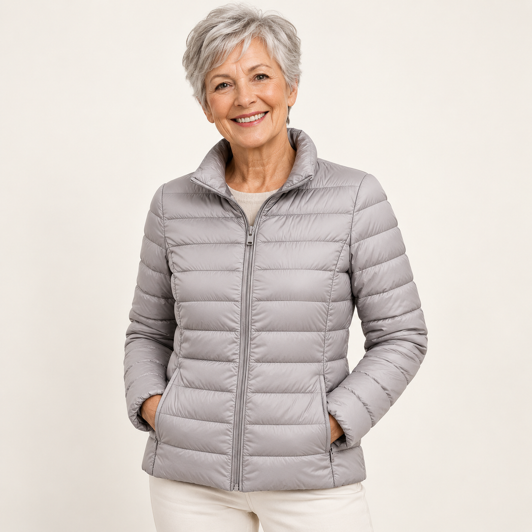 Ulla transitional padded jacket in Grey worn by a mature woman, natural studio pose