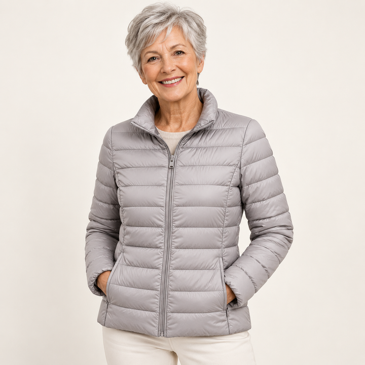Ulla transitional padded jacket in Grey worn by a mature woman, natural studio pose