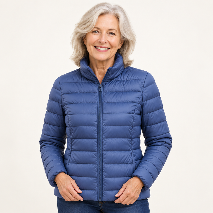 Ulla transitional padded jacket in Indigo worn by a mature woman, natural studio pose
