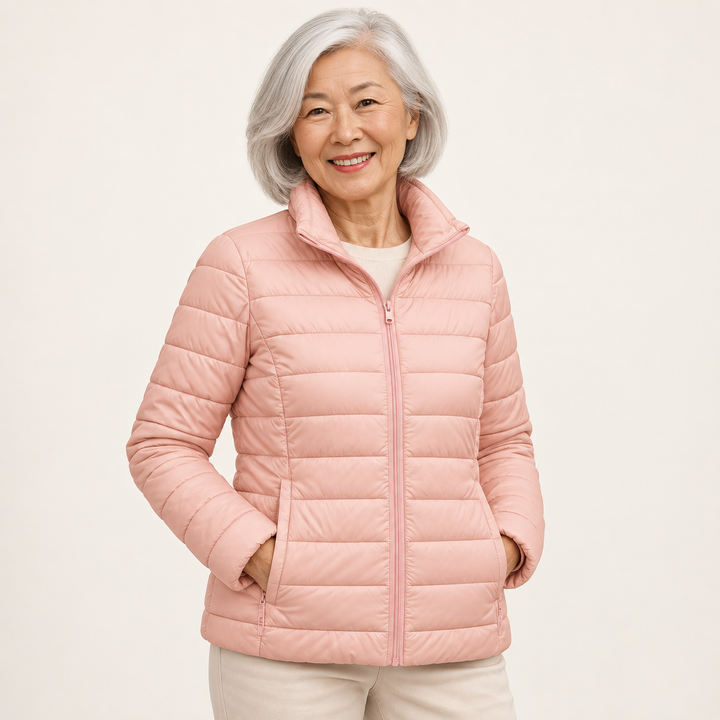 Ulla transitional padded jacket in Light Pink worn by a mature woman, three-quarter view