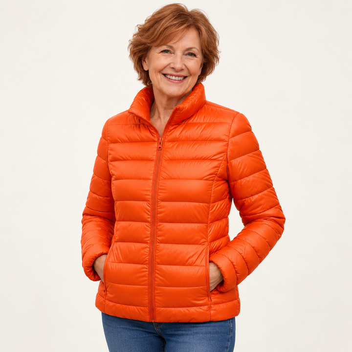 Ulla transitional padded jacket in Orange worn by a mature woman, three-quarter view