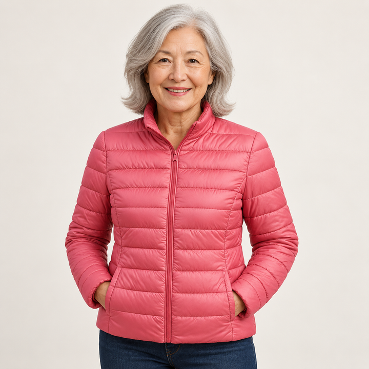 Ulla transitional padded jacket in Salmon worn by a mature woman, natural studio pose