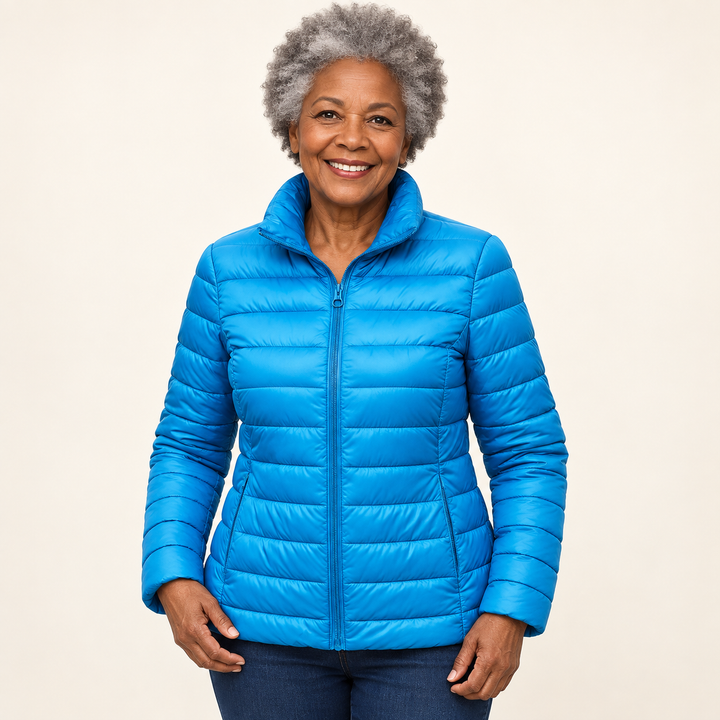 Ulla transitional padded jacket in Sky Blue worn by a mature woman, natural studio pose