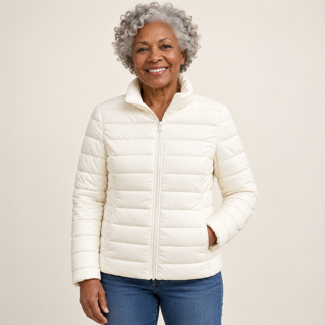 Ulla transitional padded jacket in White worn by a mature woman, natural studio pose